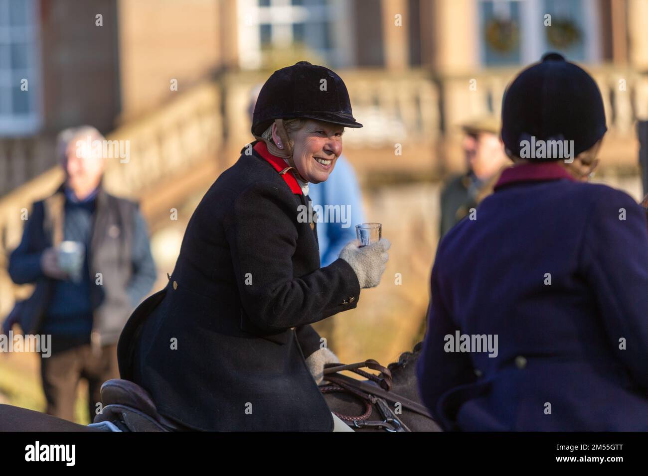 Hagley, Worcestershire, UK. 26th Dec, 2022. A lady rider sips a sherry at the Albrighton and Woodland Hunt as they meet for the traditional Boxing Day hunt at Hagley Hall. Worcestershire, on a bright and sunny day. Credit: Peter Lopeman/Alamy Live News Stock Photo