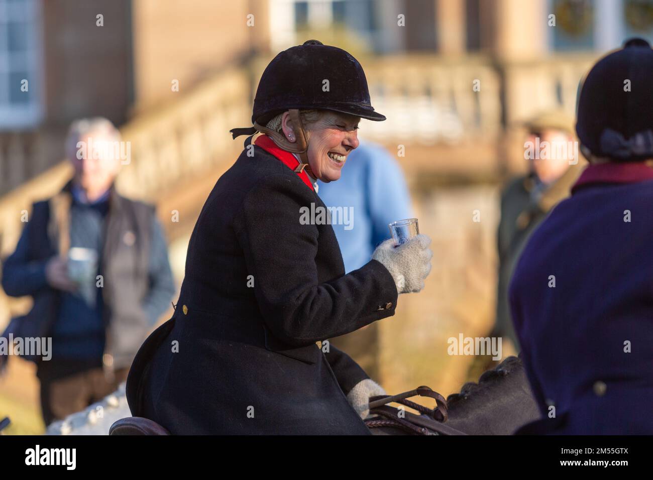 Hagley, Worcestershire, UK. 26th Dec, 2022. A lady rider sips a sherry at the Albrighton and Woodland Hunt as they meet for the traditional Boxing Day hunt at Hagley Hall. Worcestershire, on a bright and sunny day. Credit: Peter Lopeman/Alamy Live News Stock Photo