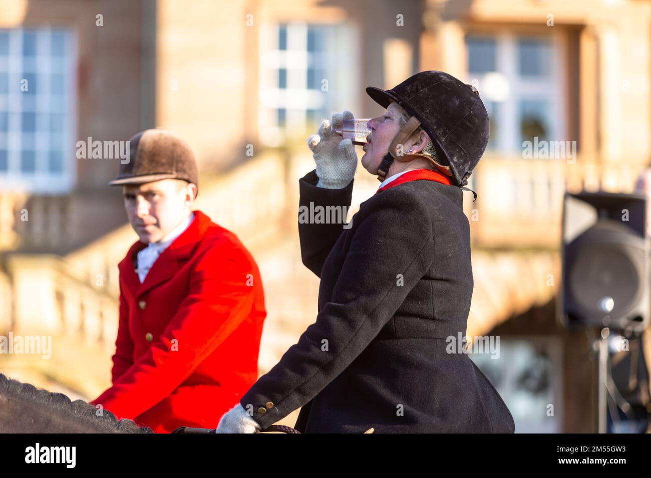 Hagley, Worcestershire, UK. 26th Dec, 2022. A lady rider sips a sherry at the Albrighton and Woodland Hunt as they meet for the traditional Boxing Day hunt at Hagley Hall. Worcestershire, on a bright and sunny day. Credit: Peter Lopeman/Alamy Live News Stock Photo