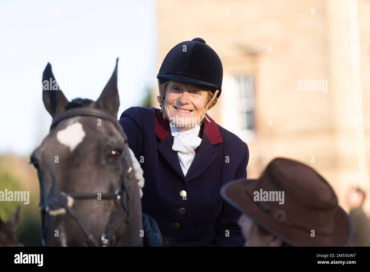 Hagley, Worcestershire, UK. 26th Dec, 2022. A lady rider looks on at the Albrighton and Woodland Hunt as they meet for the traditional Boxing Day hunt at Hagley Hall. Worcestershire, on a bright and sunny day. Credit: Peter Lopeman/Alamy Live News Stock Photo