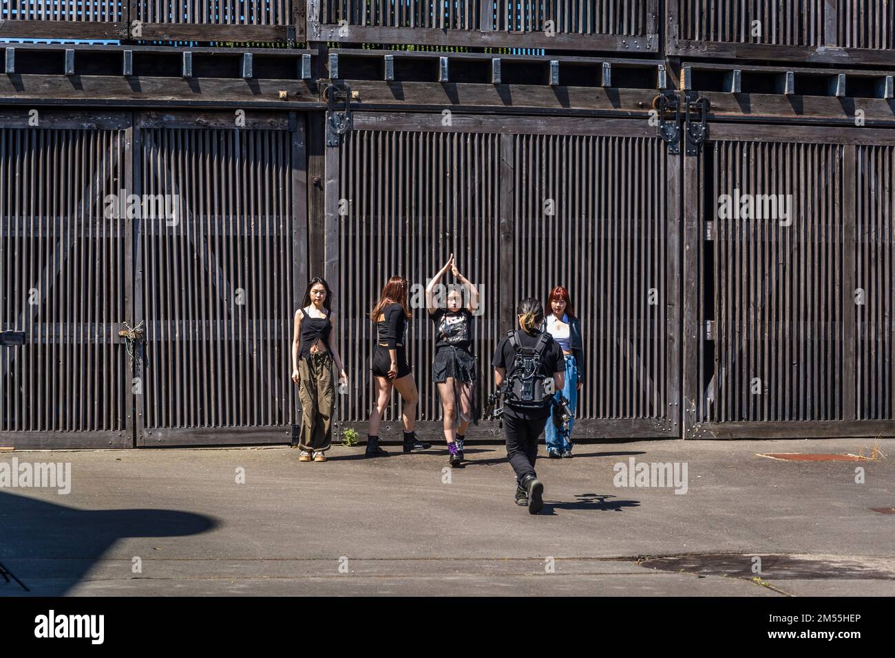 Group of girls practice dance to K-pop, short for Korean popular music with the backdrop of Disused industrial buildings, Cockatoo Island, a UNESCO Wo Stock Photo