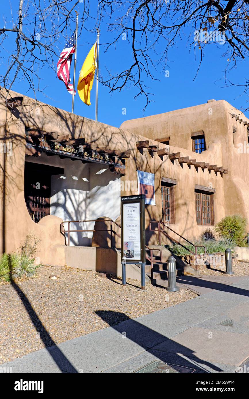 Established in 1917, The New Mexico Museum of Art on West Palace Avenue in Santa Fe, New Mexico with the US and New Mexico flags on November 11, 2022. Stock Photo