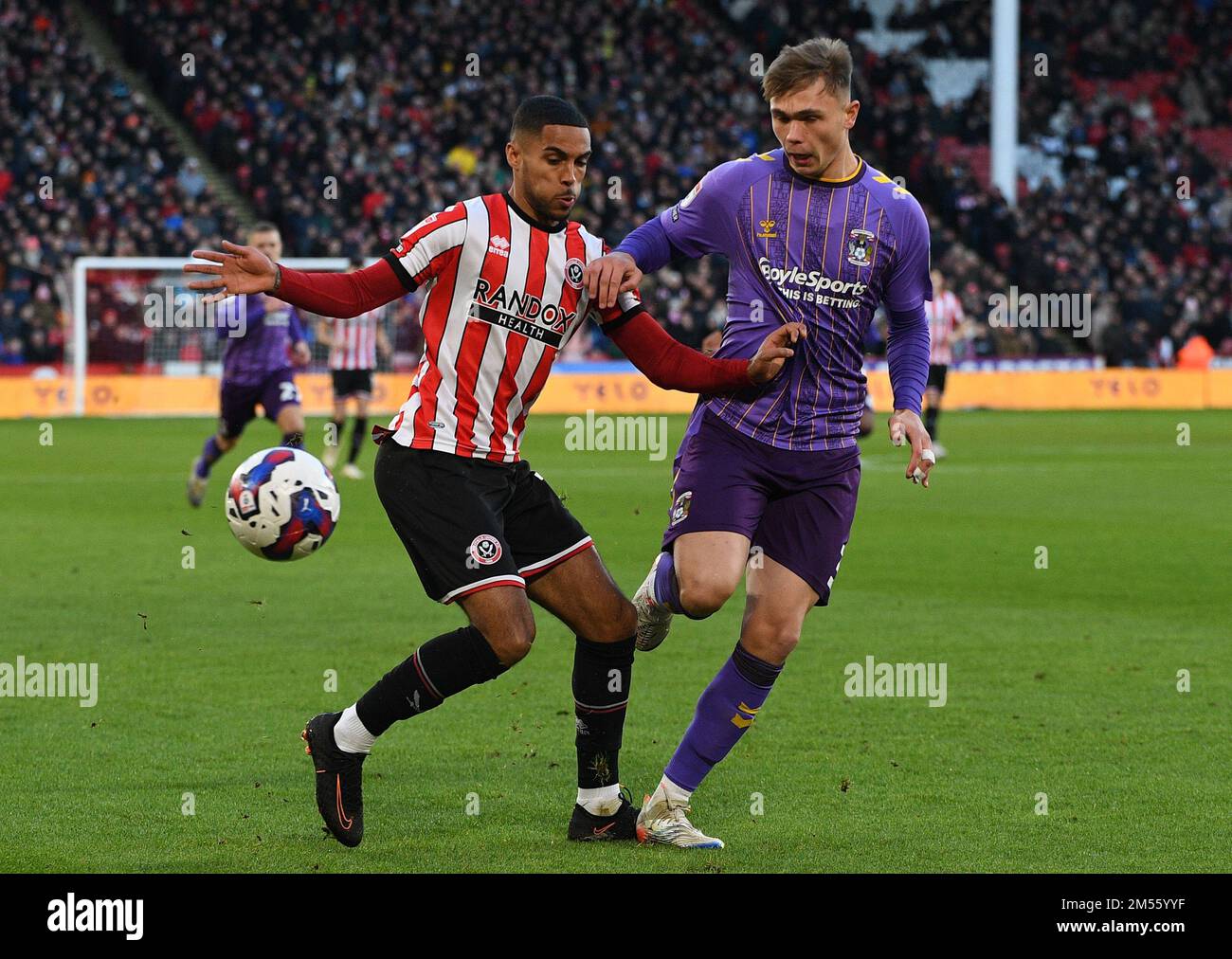 Sheffield, England, 26th December 2022. Max Lowe of Sheffield Utd held up by Callum Doyle of Coventry City  during the Sky Bet Championship match at Bramall Lane, Sheffield. Picture credit should read: Gary Oakley / Sportimage Credit: Sportimage/Alamy Live News Stock Photo