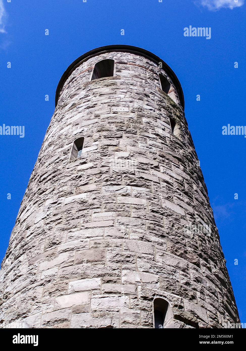 Irish round tower against a blue sky Stock Photo - Alamy