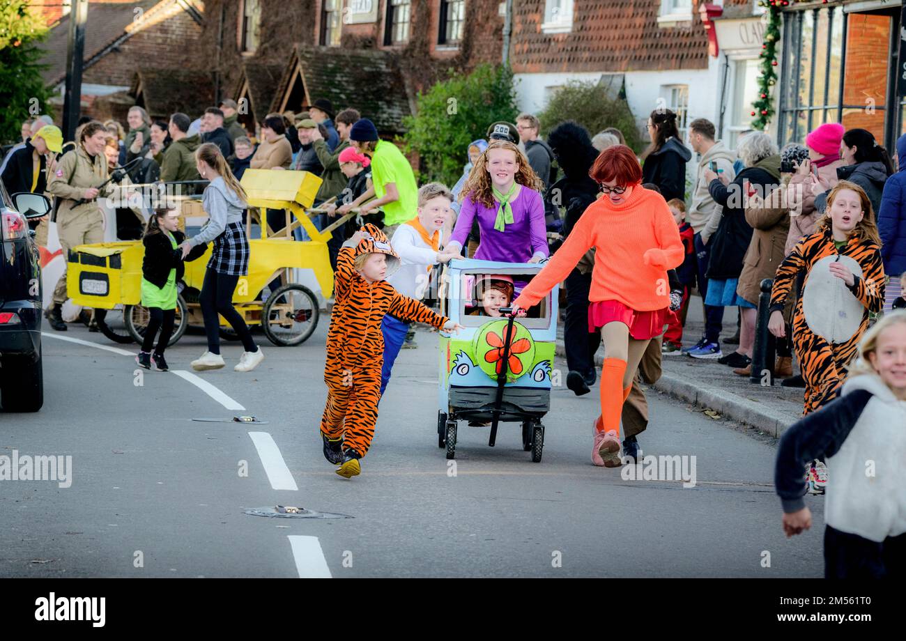 East Hoathly, UK. 26th Dec, 2022. Boxing Day pram race: Teams in fancy dress race through the village of East Hoathly in East Sussex raising funds for local charities. The annual event begins and ends at the Kings Head pub in the centre of the village. Credit: Jim Holden/Alamy Live News Stock Photo
