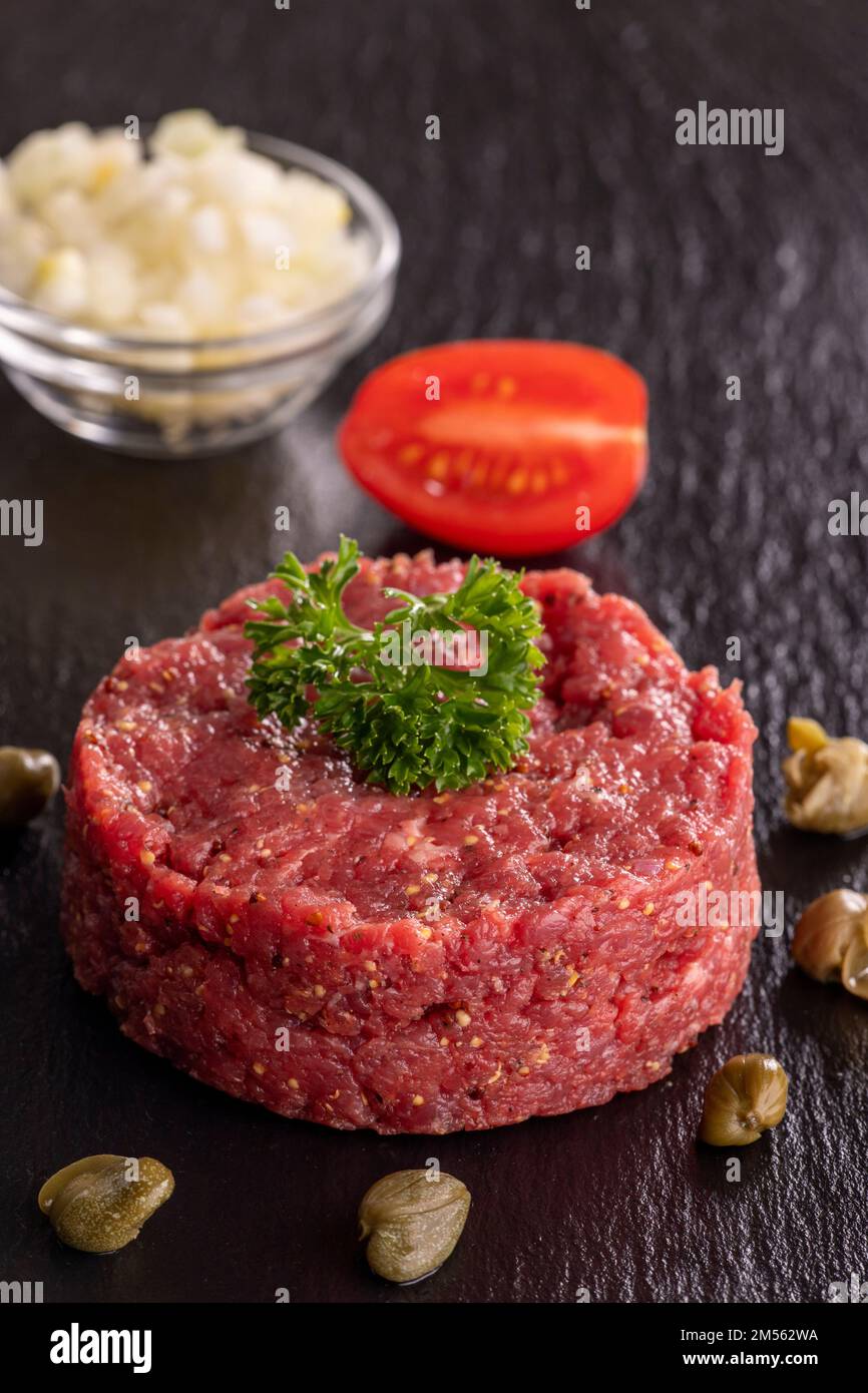 steak tartare on black slate Stock Photo Alamy