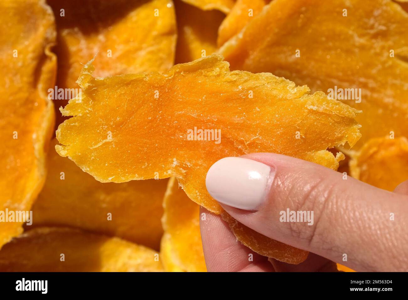 Dried mango slices closeup on a white. Top view. Closeup. Mango chips