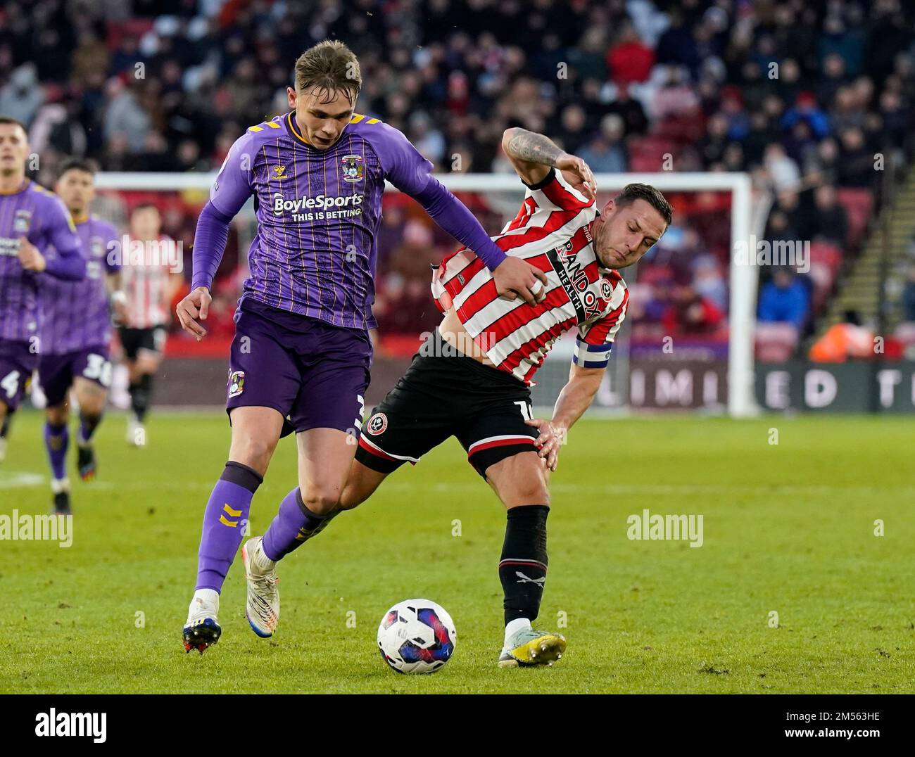 Sheffield, England, 26th December 2022. Callum Doyle of Coventry City tussles with Billy Sharp of Sheffield Utd  during the Sky Bet Championship match at Bramall Lane, Sheffield. Picture credit should read: Andrew Yates / Sportimage Credit: Sportimage/Alamy Live News Stock Photo