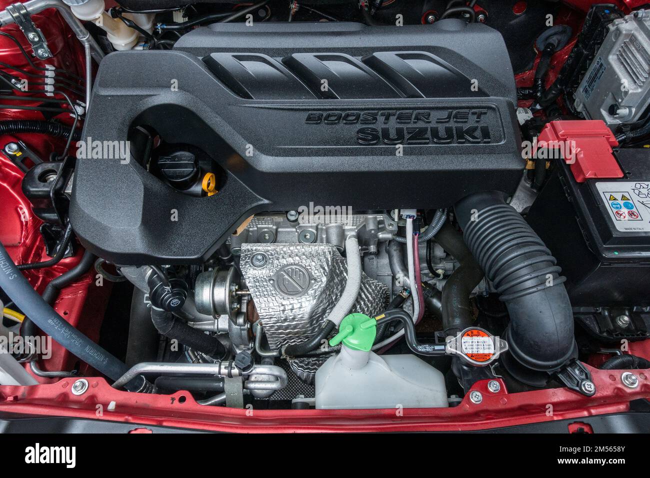 Modern 1 litre 3 cylinder turbocharged high efficiency Suzuki 'Boosterjet' petrol engine under bonnet of new Suzuki SX4 S-Cross SUV car Stock Photo