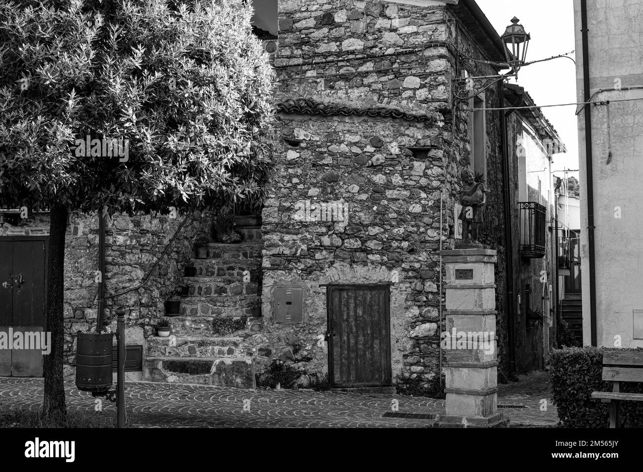 A grayscale of and old house, stone building and a stairway in Sarconi, Basilicata in Italy Stock Photo