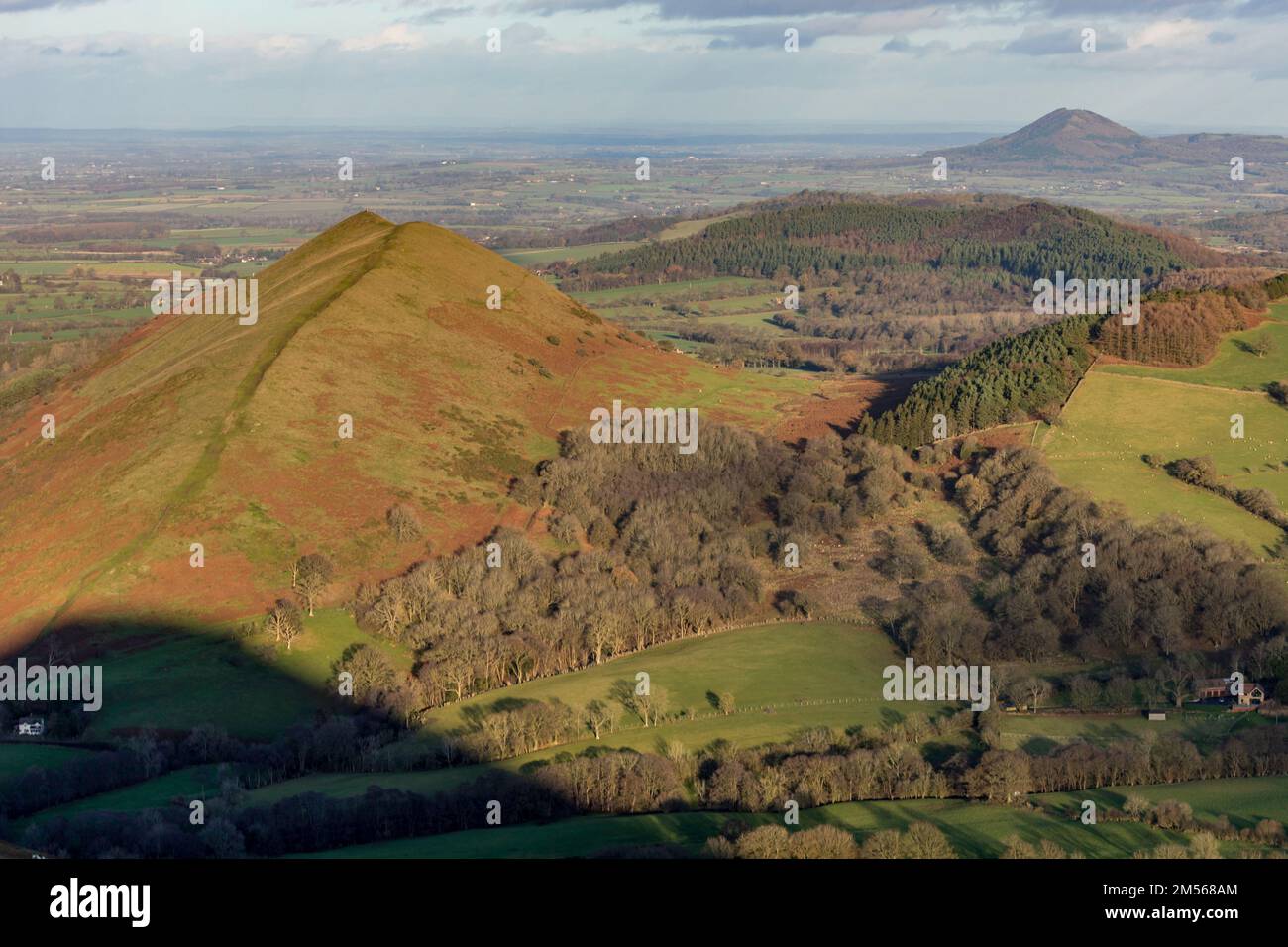 The Lawley, hill in Shropshire, England, with The Wrekin, another hill in the background. The shadow of Caer Caradoc in the forground. Stock Photo