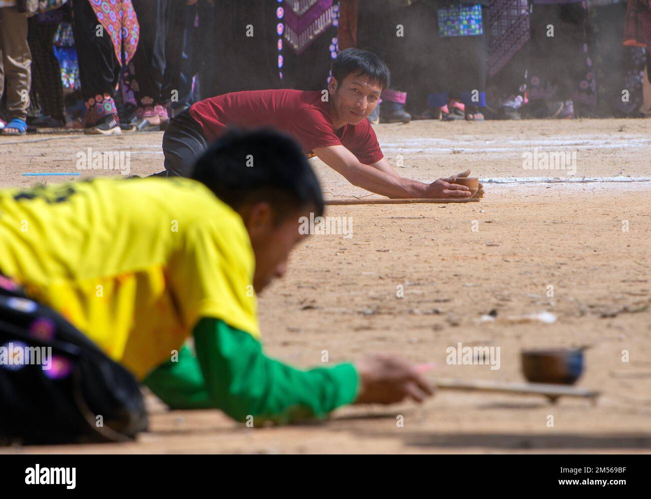 Hmong hill tribe men playing top spinning competition (traditional game
