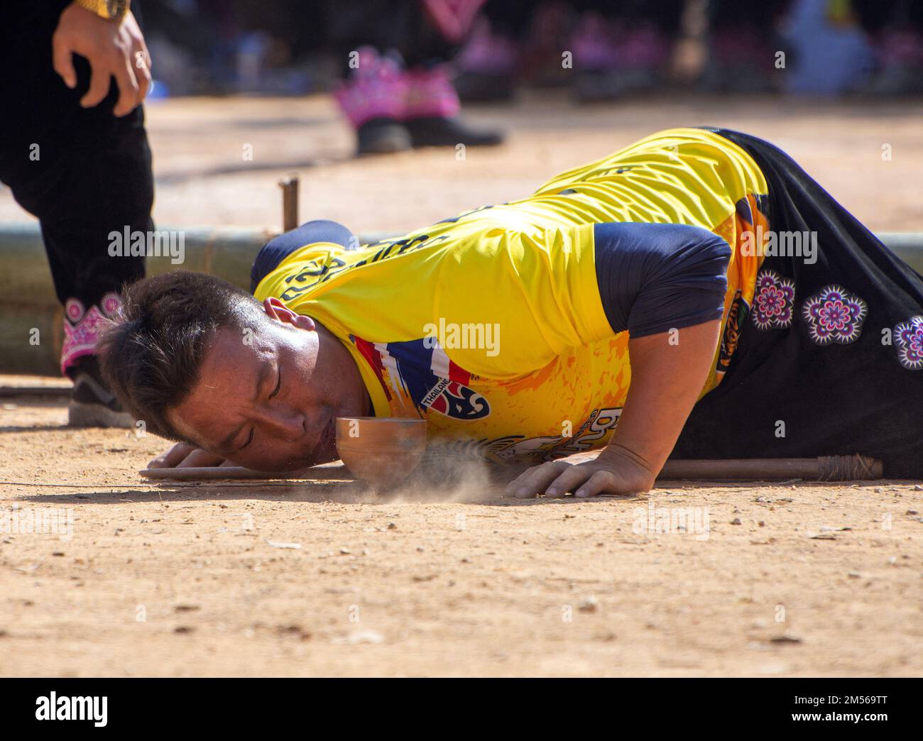 A Hmong hill tribe man playing top spinning competition (traditional