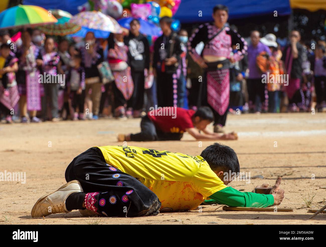 Hmong hill tribe men playing top spinning competition (traditional game