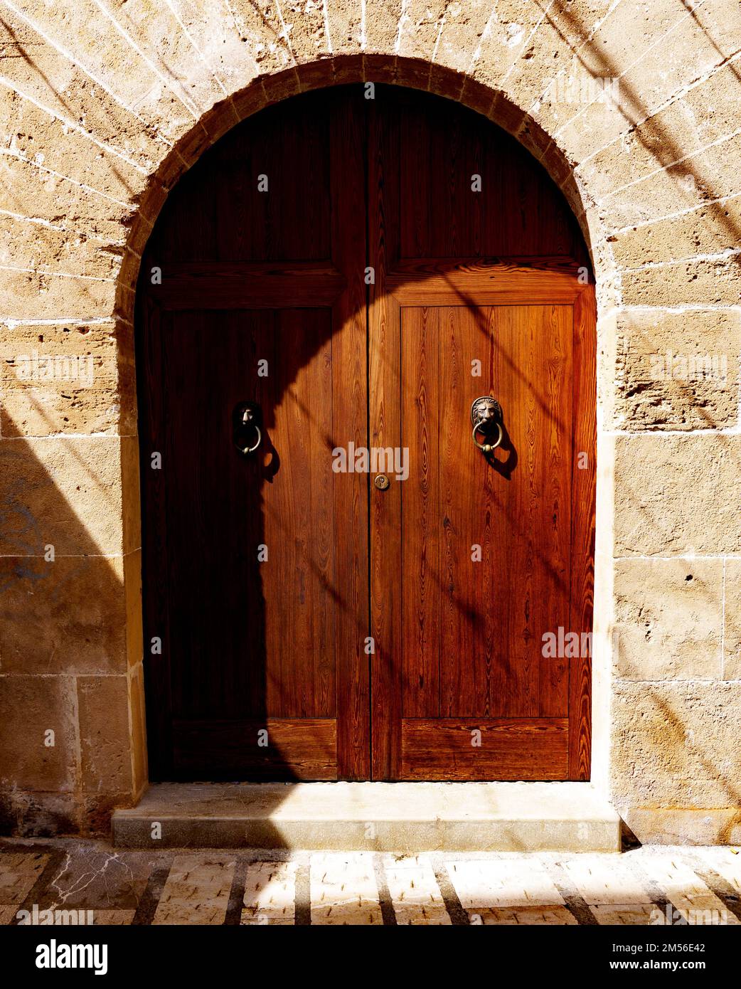 Old wooden door of a mediterranean stone house Stock Photo - Alamy