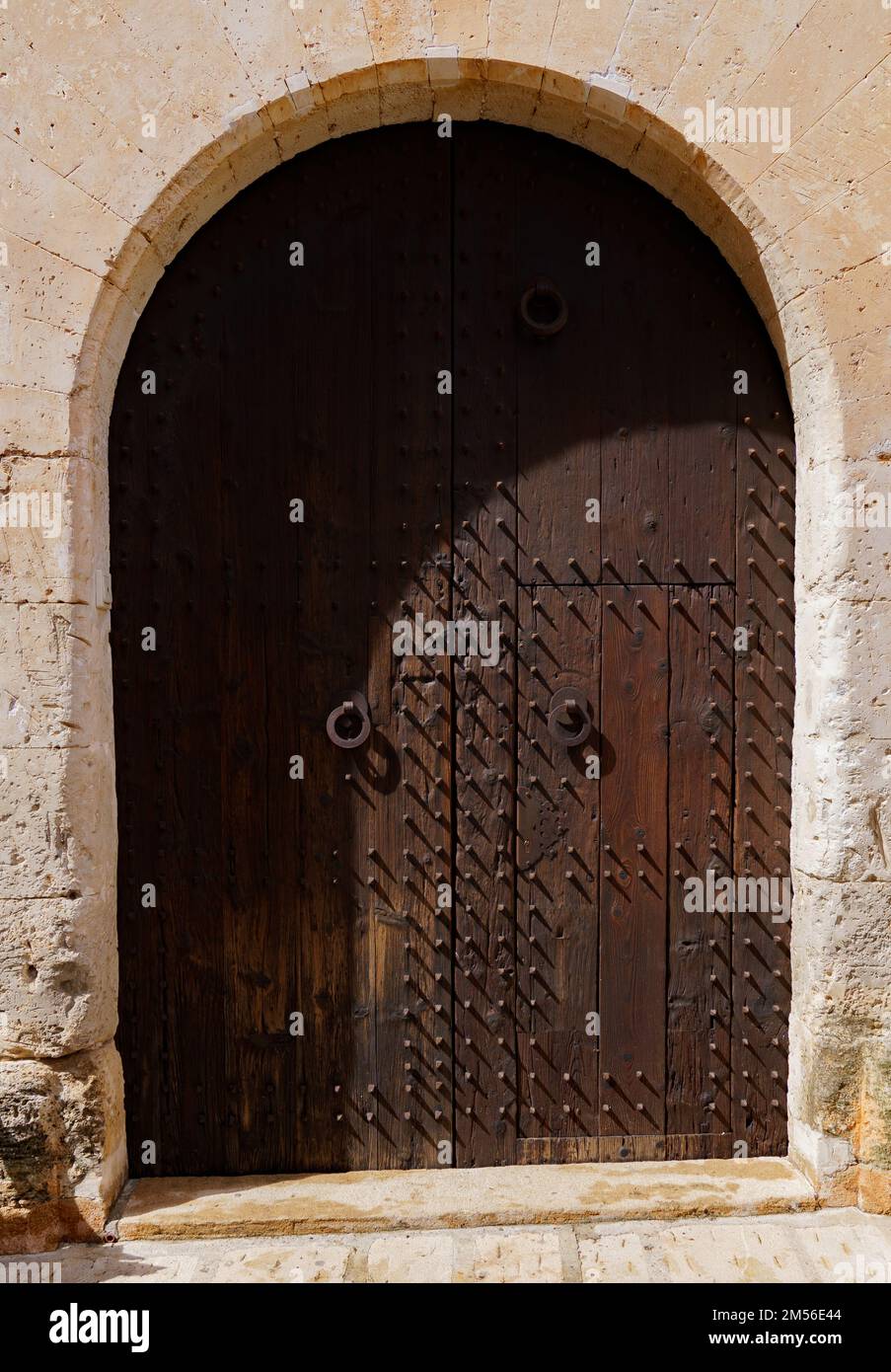 Wooden dark brown door of old stone house Stock Photo - Alamy