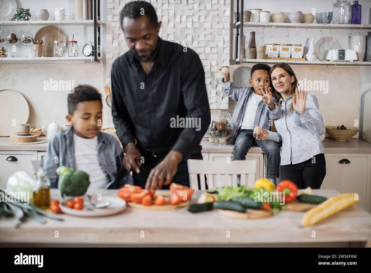 Mother cooking dinner on kitchen with her little cute kid Stock Photo -  Alamy