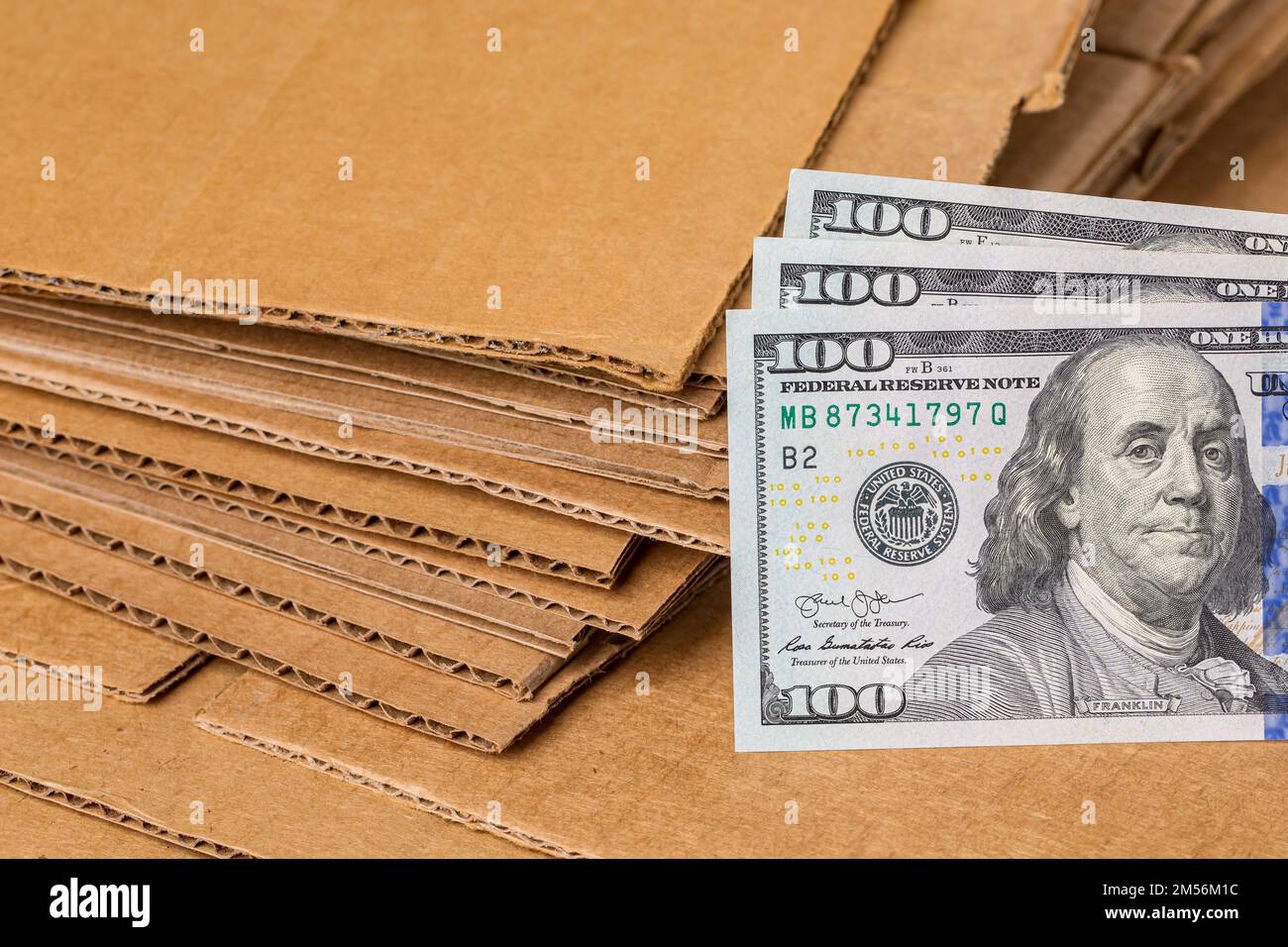 Corrugated cardboard and cash money. Paper recycling, disposal and