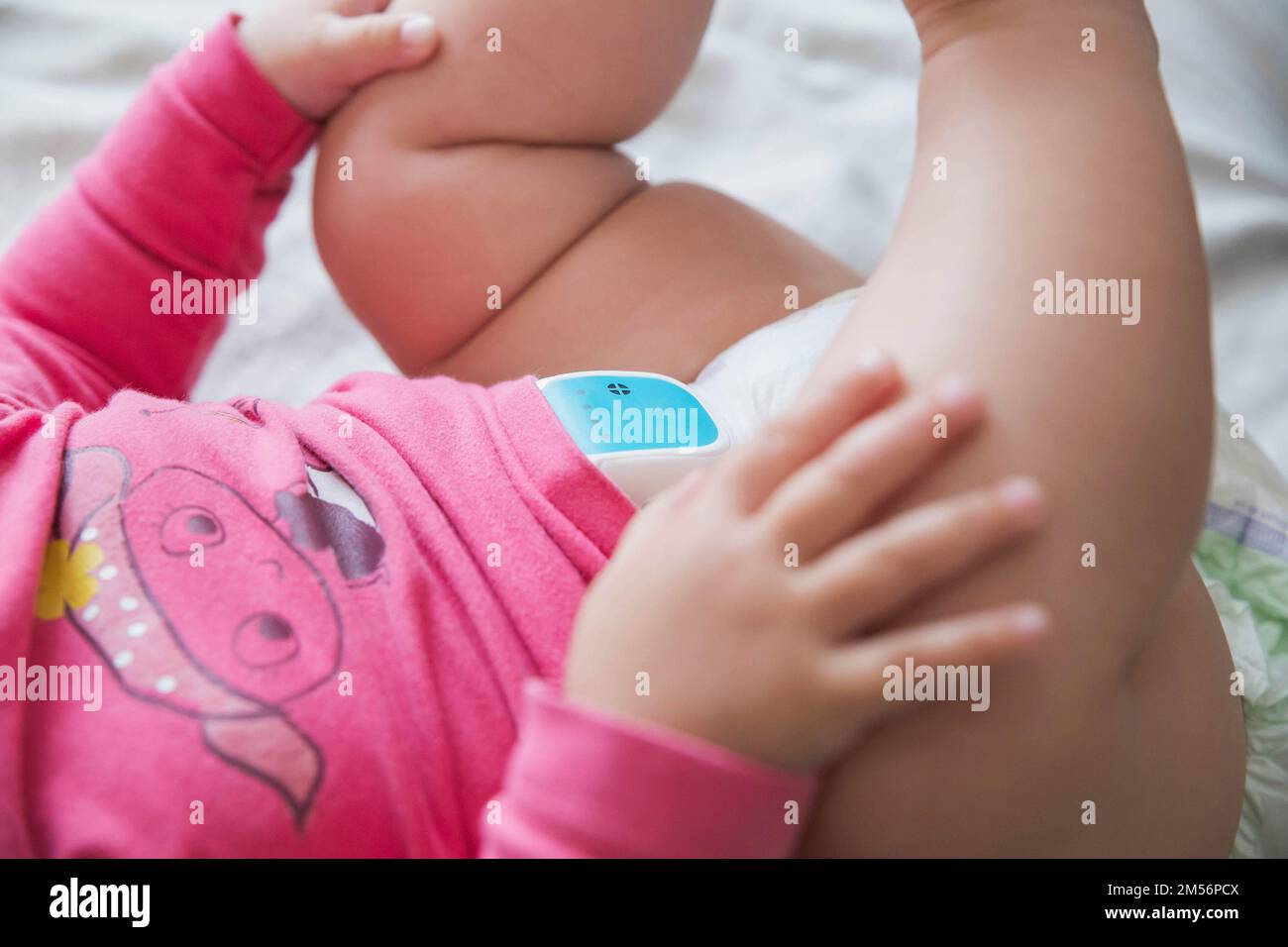device that clings to the diaper to protect the baby from sleep apnea syndrome Stock Photo