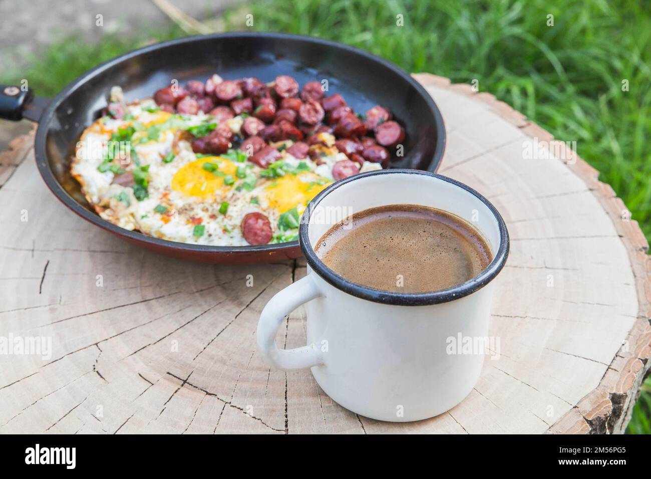 breakfast in the forest: scrambled eggs with sausage and coffee Stock ...