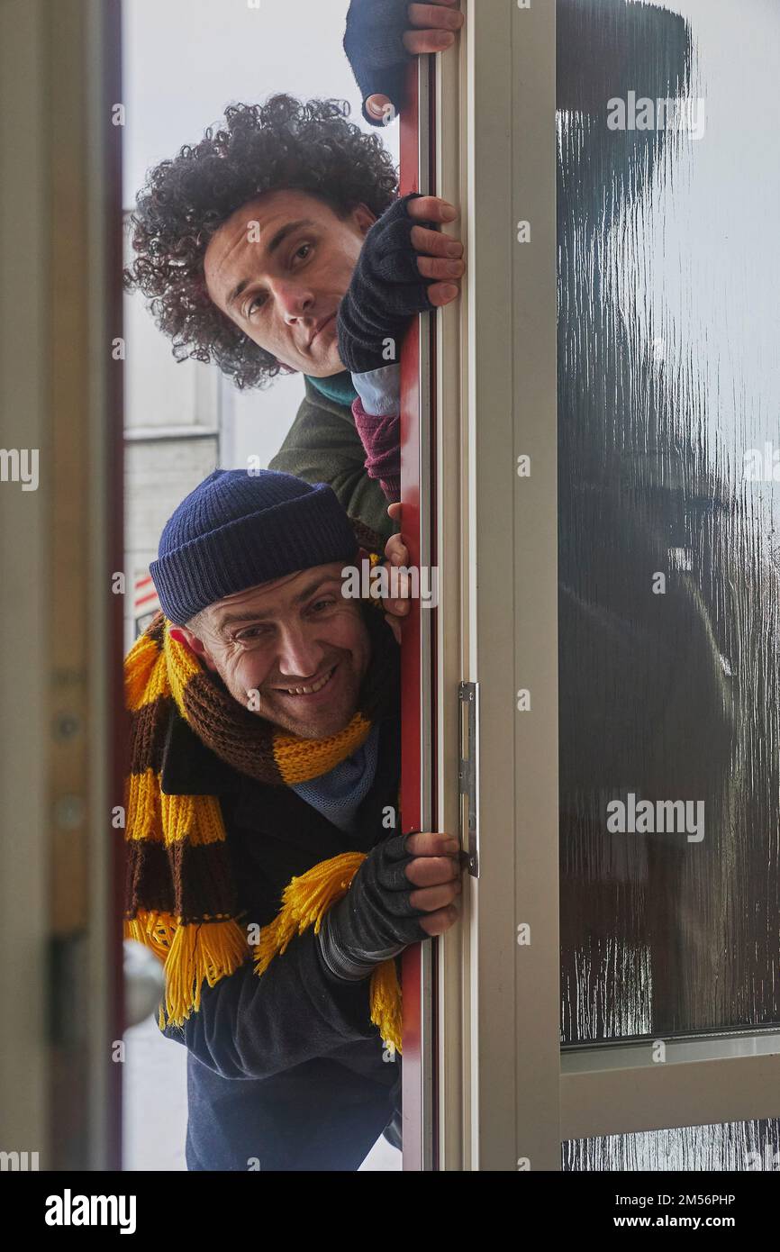 Skive, Denmark, December 2022: Delivery workers pretend to be robbers  Stock Photo
