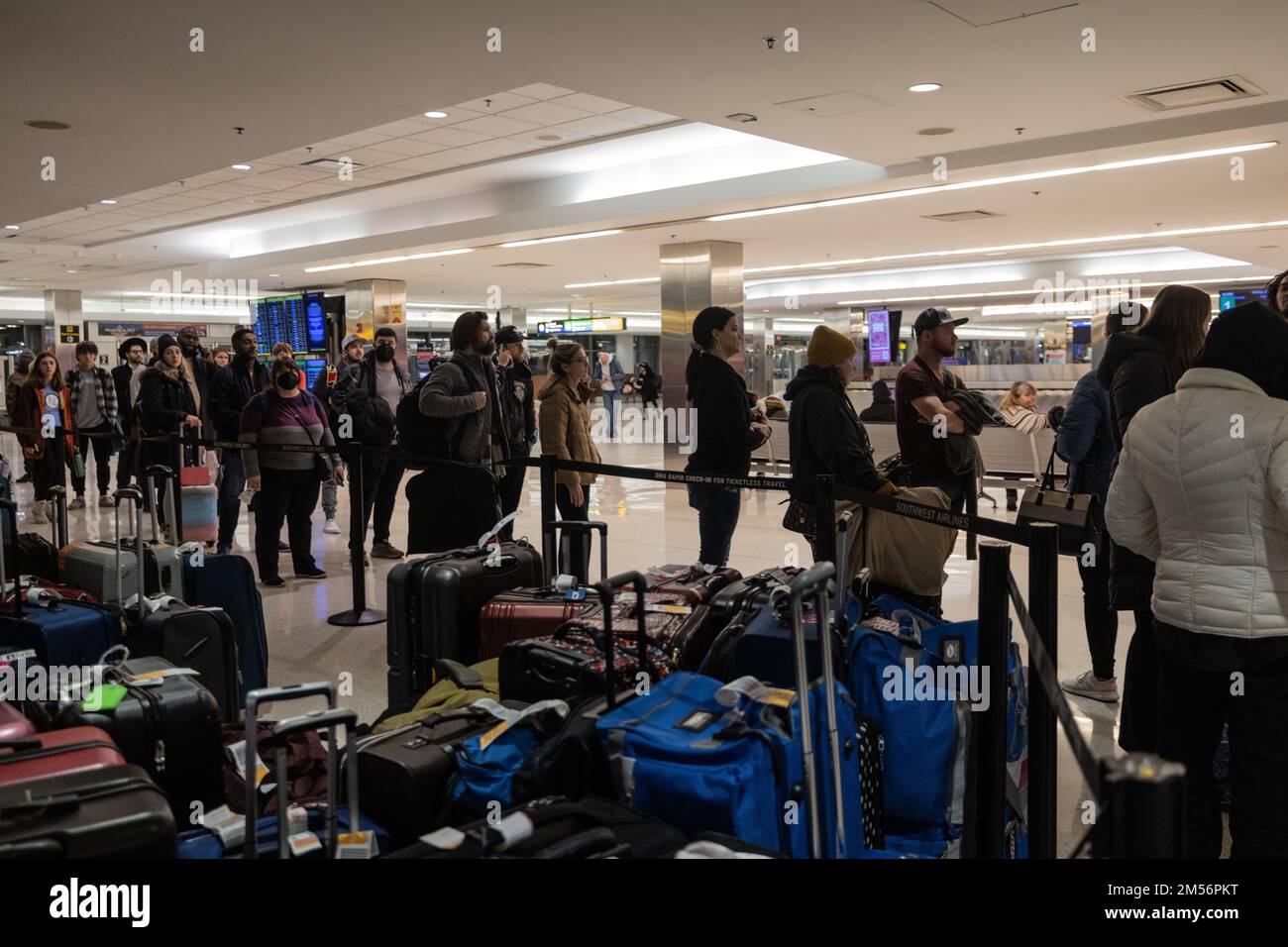 Dmv, Usa, USA. 26th Dec, 2022. Travelers wait among lost luggage at the