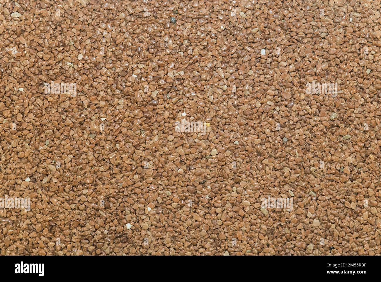 brown pavement lined with tiny round pebbles  Stock Photo