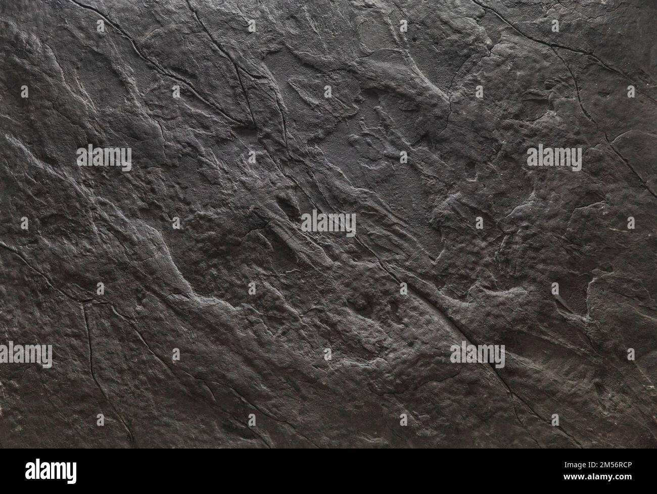 Cracked stone background painted black. Space for text Stock Photo