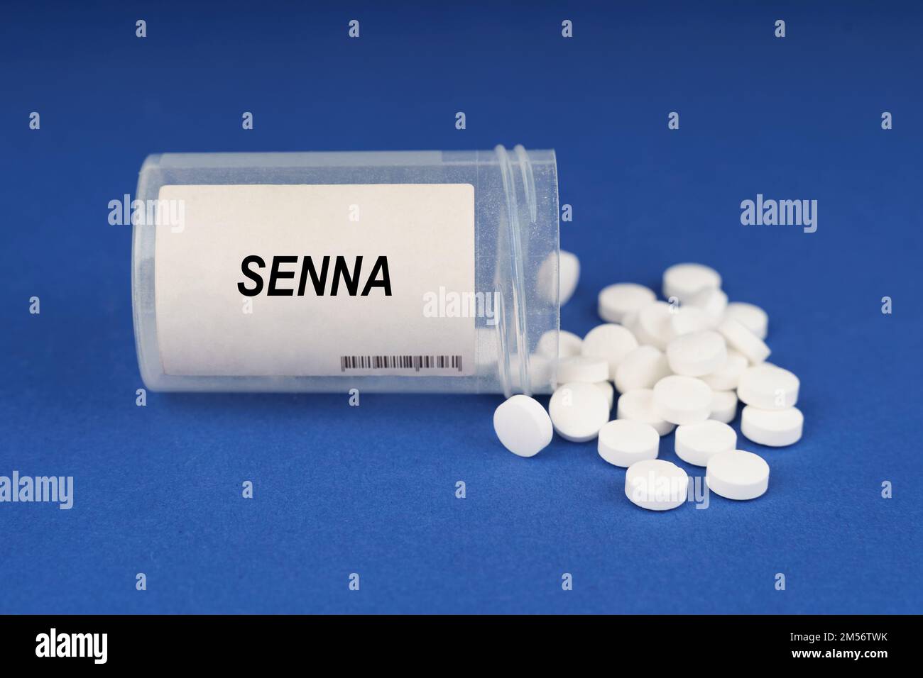 The concept of pharmacology and health. On a blue surface are pills and a dusty jar with the inscription - Senna Stock Photo