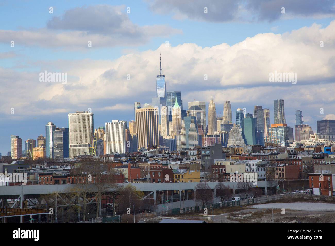 Lower Manhattan skyline shooting up behind Brooklyn neighborhoods in the foreground. Stock Photo
