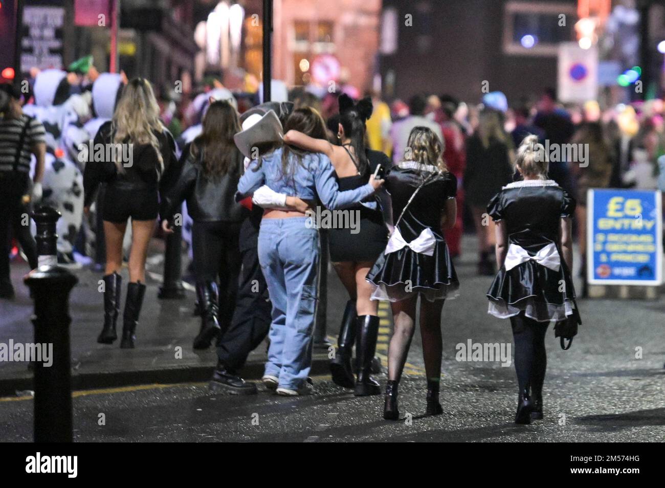 King Street, Wigan, December 26th 2022. - Revellers in various fancy dress outfits from traffic cones to Beetlejuice to sexy Peaky Blinders have hit the streets of Wigan on Boxing Day evening in the annual infamous event that is open to any ideas with no theme. Partygoers dressed in hilarious outfits hit King Street and Wallgate which houses many nightclubs and bars. Greater Manchester Police watched on as the mayhem ensued. Credit: Ben Formby/Alamy Live News Stock Photo