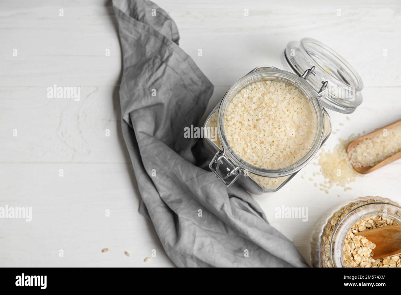 Jar with rice on light wooden background Stock Photo - Alamy