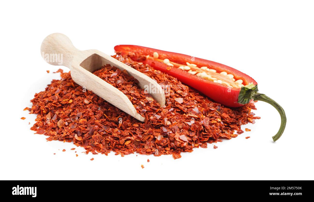 Heap of chipotle chili flakes and scoop on white background Stock Photo