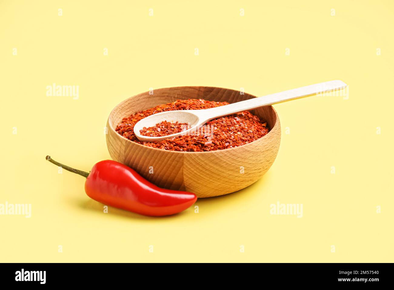 Bowl of chipotle chili flakes on yellow background Stock Photo Alamy