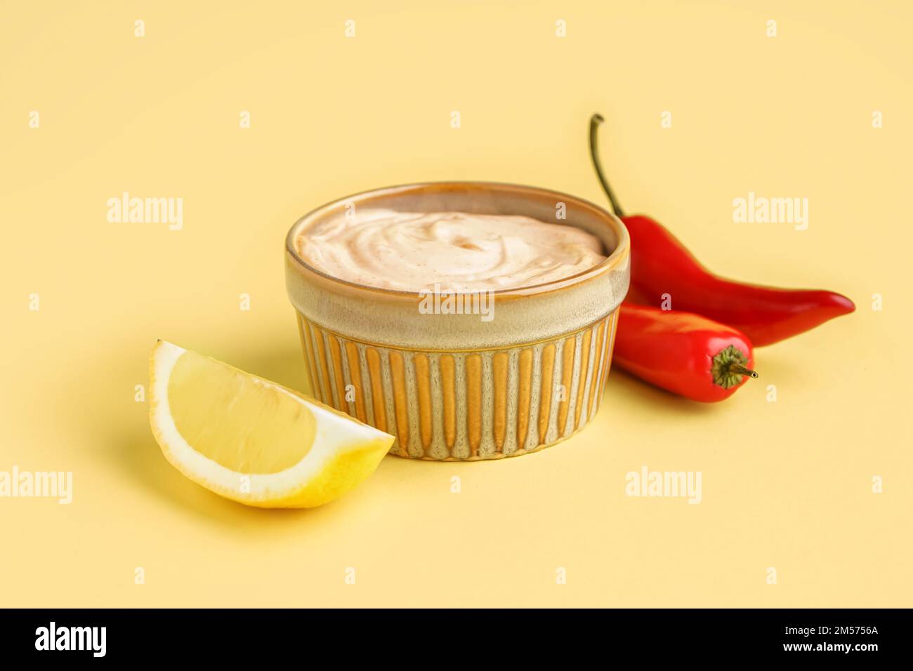 Bowl of tasty chipotle sauce on yellow background Stock Photo