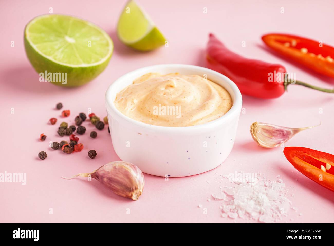 Bowl of tasty chipotle sauce on pink background Stock Photo