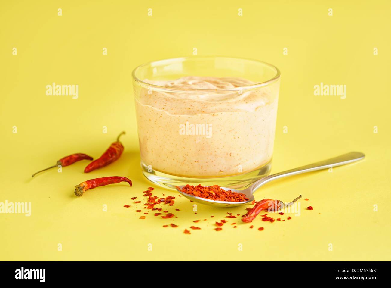 Bowl of tasty chipotle sauce on yellow background Stock Photo