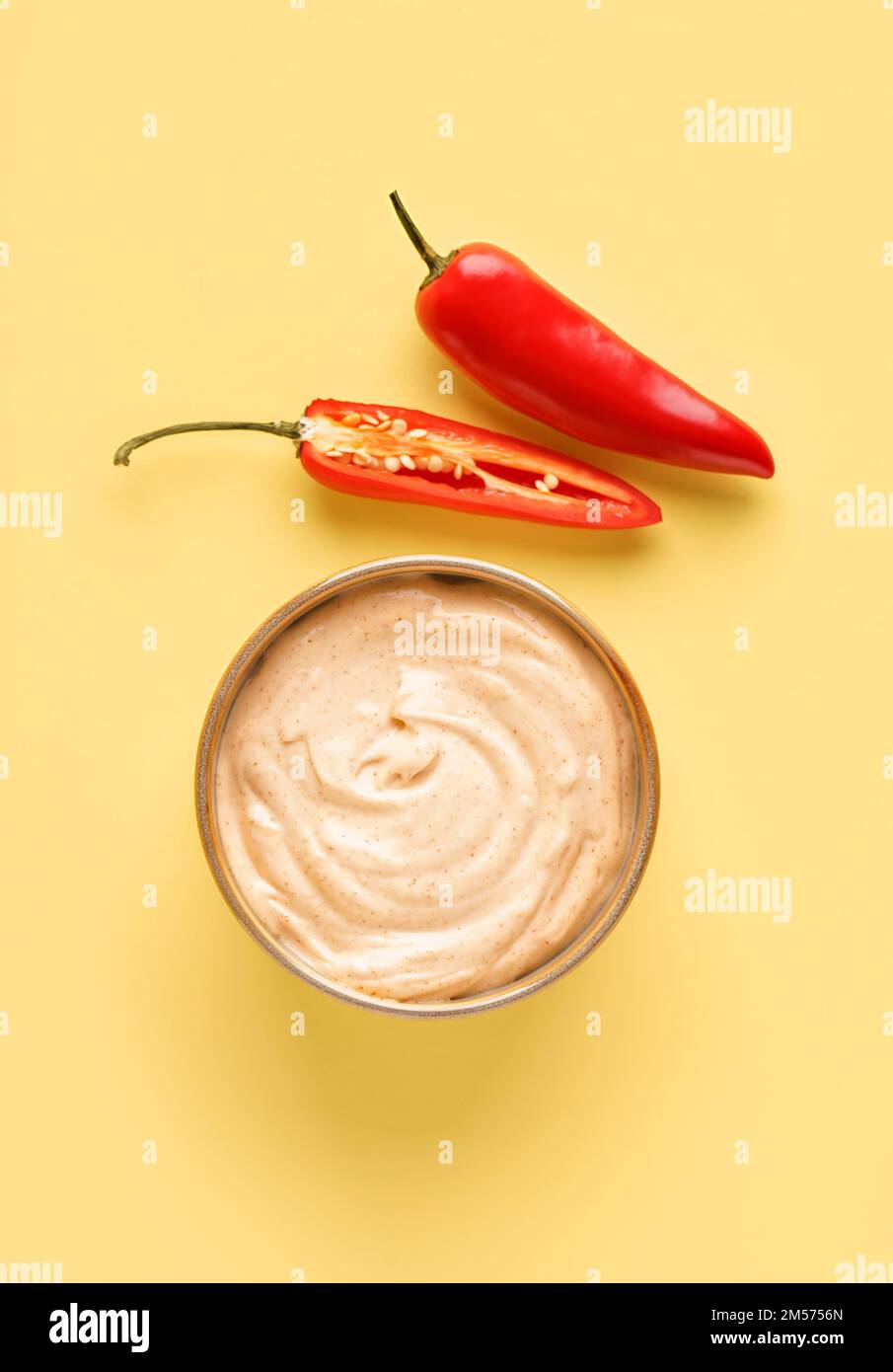 Bowl of tasty chipotle sauce on yellow background Stock Photo