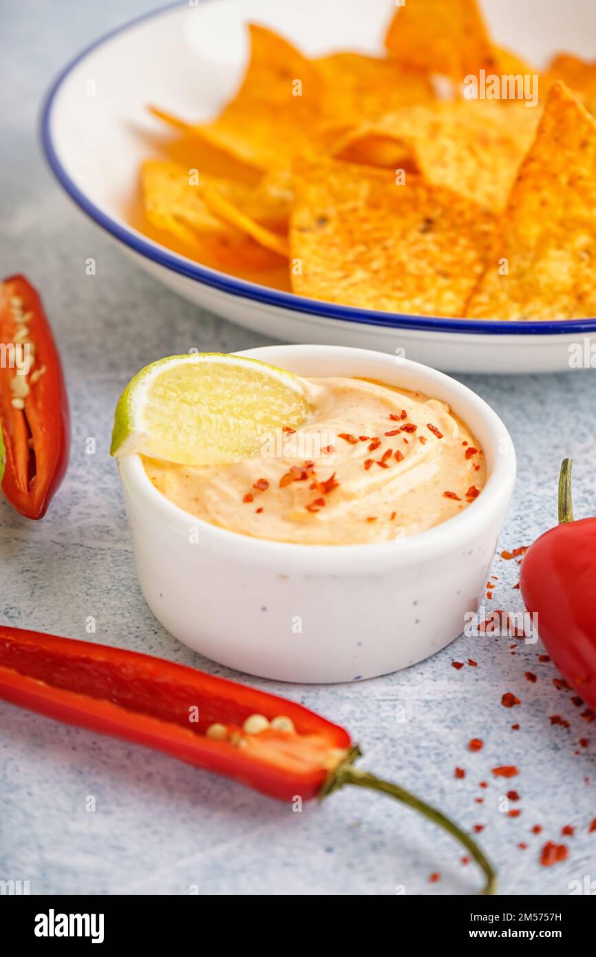 Bowl of tasty chipotle sauce on light background Stock Photo