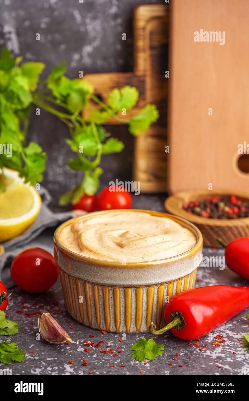 Bowl of tasty chipotle sauce on grunge background Stock Photo