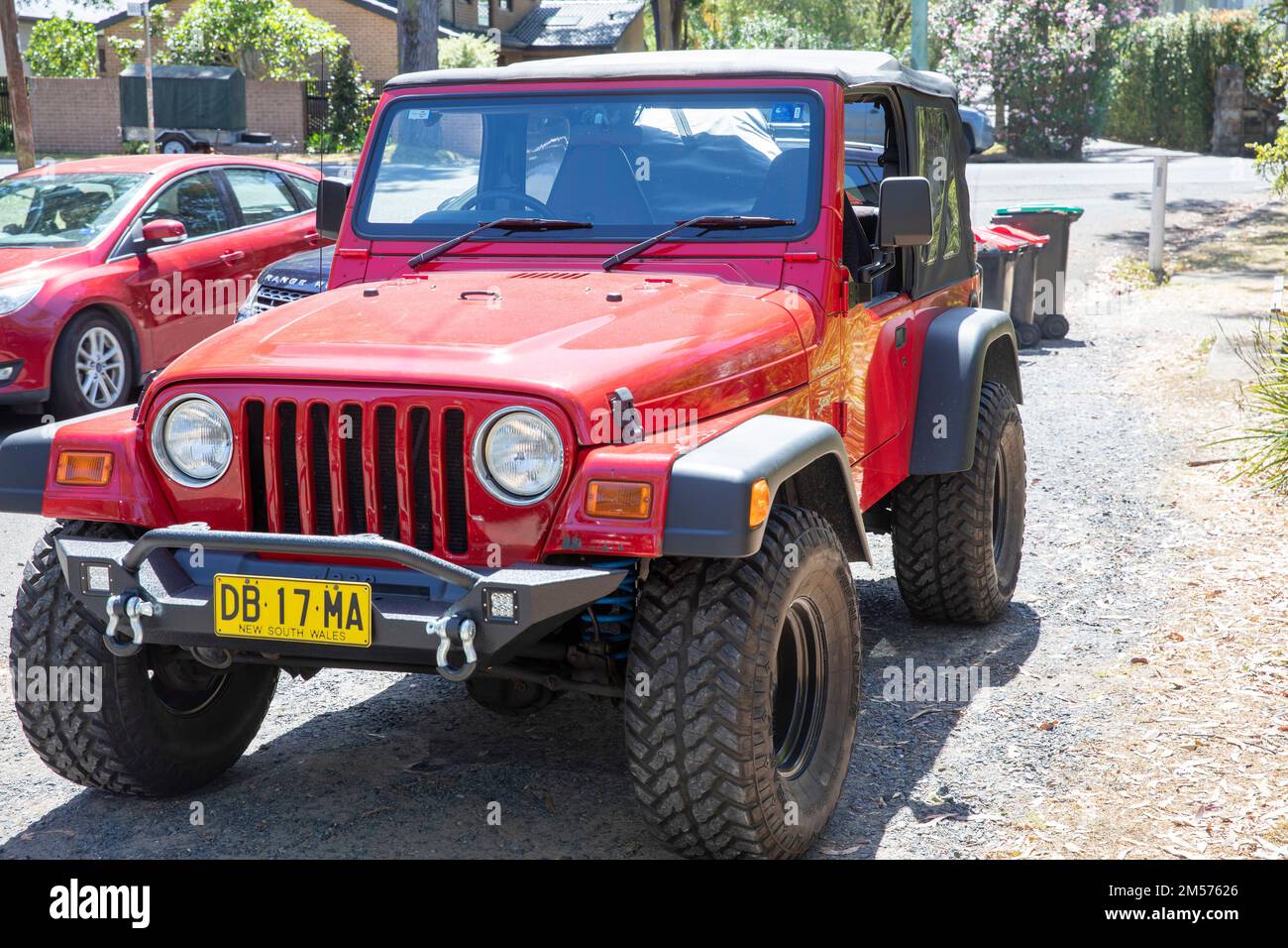 2000 model red Jeep Wrangler 4x4 parked in a side street in Palm Beach