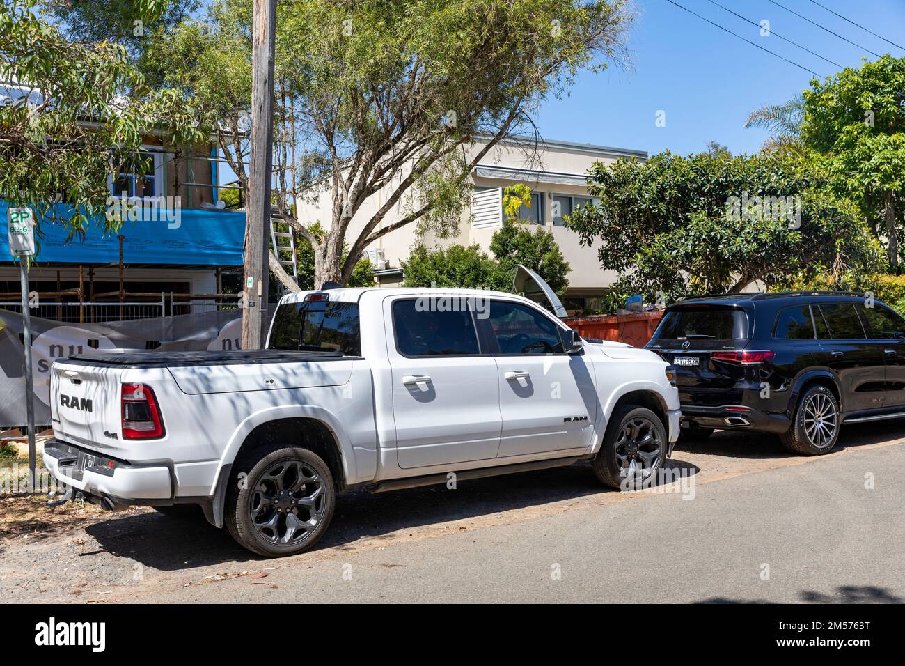White RAM truck model year 2021, side view drivers side parked in a