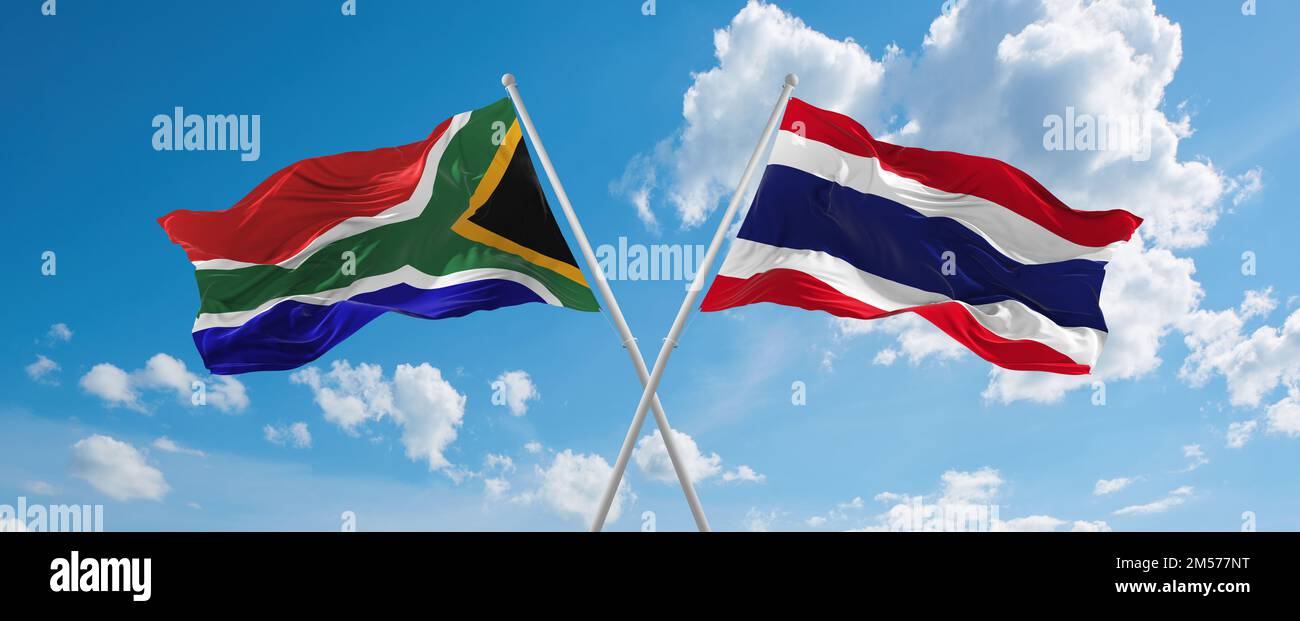 two crossed flags thailand and South Africa waving in wind at cloudy ...