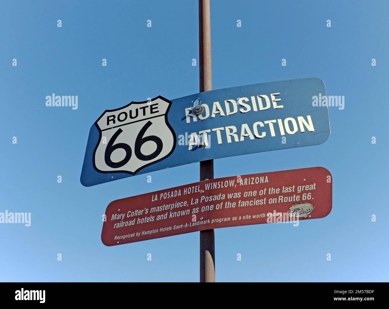 Route 66 roadside attraction sign in Winslow, Arizona honors La Posada Hotel and Mary Colter, the architect.  La Posada is a historic landmark. Stock Photo