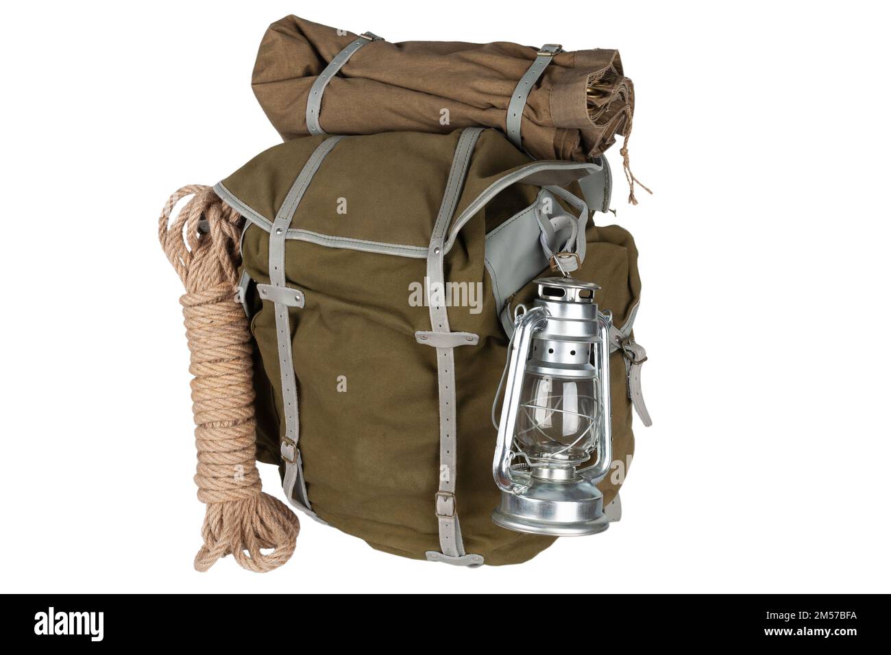Antique vintage backpack with rope and gas lantern isolated on white