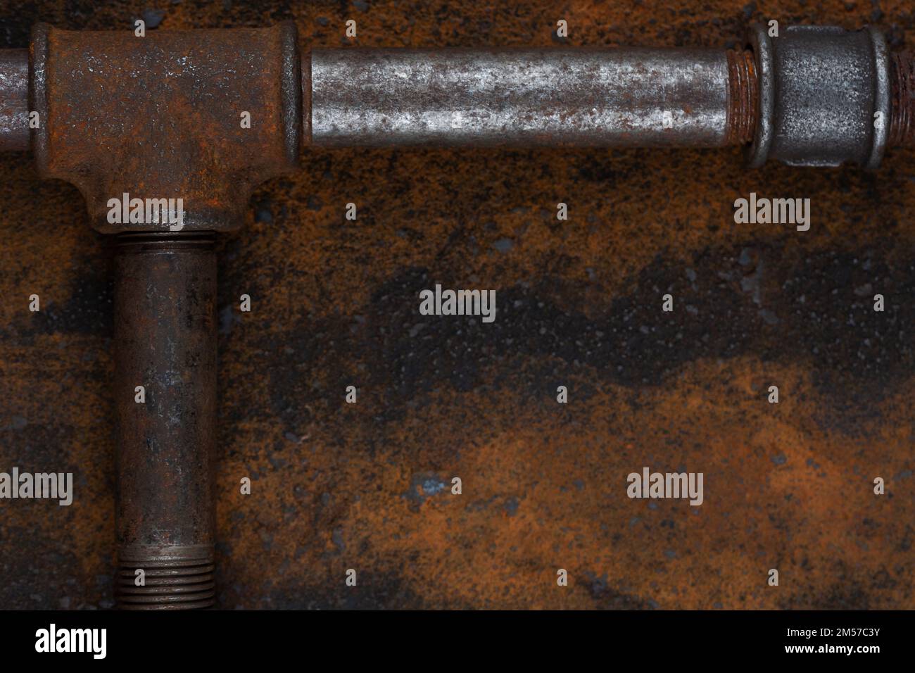 Old rusty valve pipes on rusty metal wall background Stock Photo - Alamy