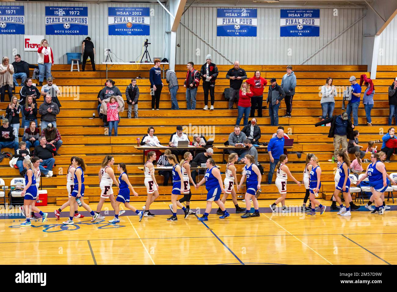 Members of the Fremont High School girls' basketball team congratulate the Bethany Christian HS basketball team after a game in Goshen, Indiana, USA. Stock Photo