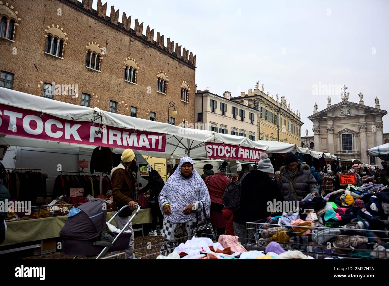 Stalls  on a square with people browsing on a cloudy day Stock Photo