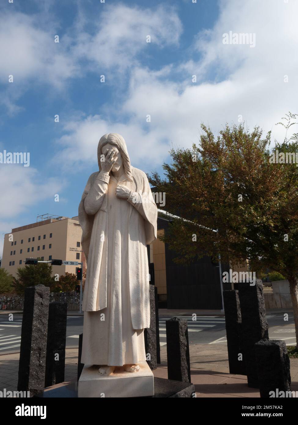 'And Jesus Wept' statue erected by the St. Joseph Catholic Church across the street from the Oklahoma City National Memorial and Museum. Stock Photo