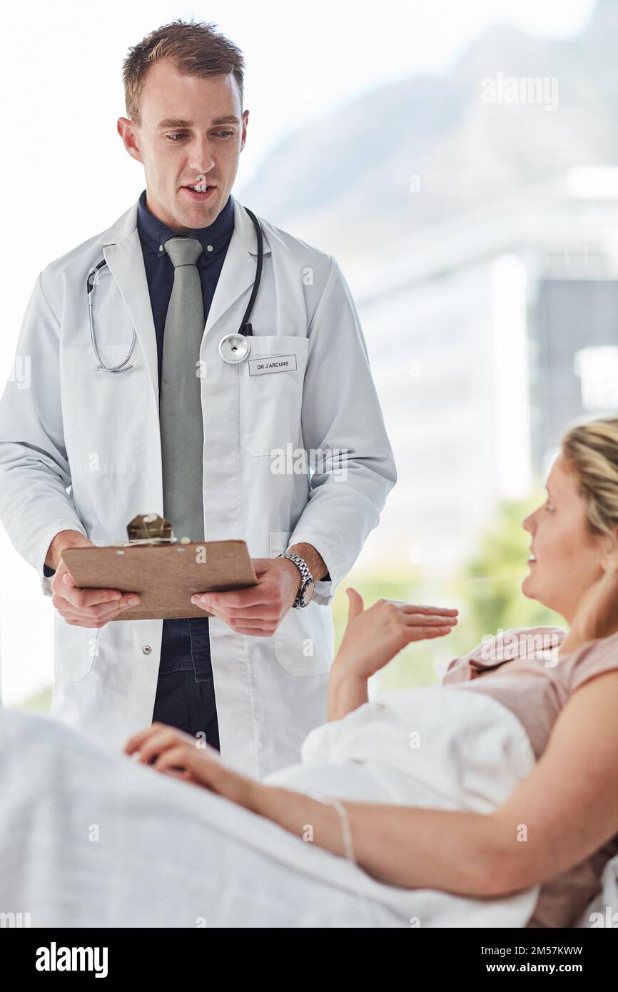 Offering guidance to her health concerns. a male doctor giving feedback to a patient in a
